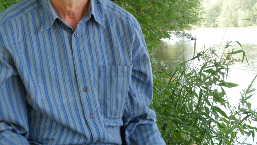 fisherman holding up the big trophy salmon fish by the river 