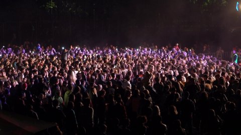 Kiev, Ukraine, Europe - September 15, 2019: Many spectators in front of the stage waving their hands. Open air music festival "SolomaFest". Fans dance in front of the stage at the concert.