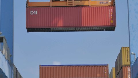 Haifa, Israel - 12.9.2019 : Port crane lifting container and from cargo ship 4k for shipping business