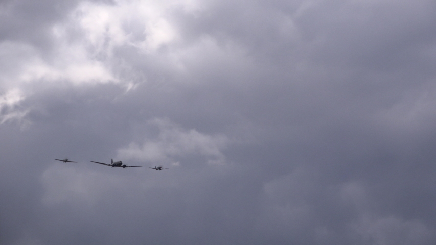 DC 3 Douglas in blue sky with white clouds flying overhead and against clouds UK 4K