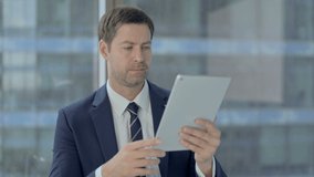 Cheerful Businessman Doing Video Chat on Tablet