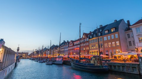 Copenhagen Denmark time lapse 4K, city skyline day to night sunset timelapse at Nyhavn harbour