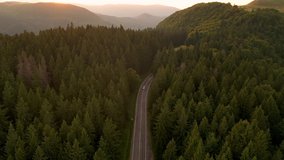 Aerial drone video with a mountain winding road in autumn season at sunset