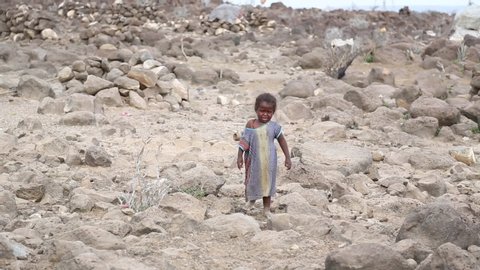 Djibouti / Djibouti - May 2 2014: barefoot poor girl crying and going to her mom.