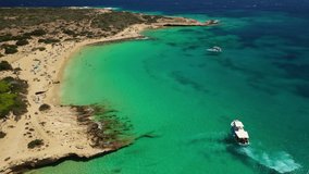 Aerial drone video of iconic breathtaking turquoise sandy beach of Platia Pounta or Italida in famous island of Koufonissi, Small Cyclades, Greece