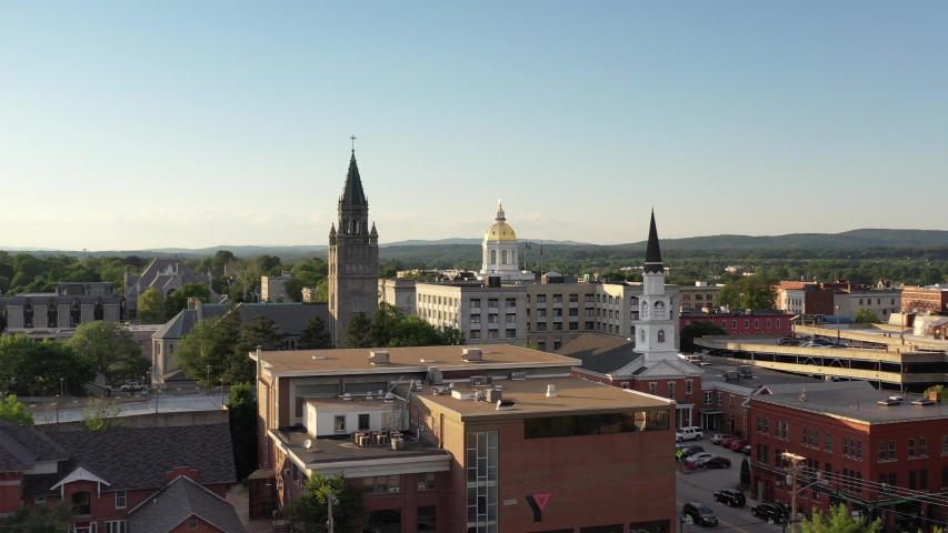 Concord, New Hampshire, USA: Aerial drone footage of city skyline with State House gold dome roof	