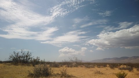 Arid Mojave Desert During Drought, Panning Timelase of Fluffy Clouds