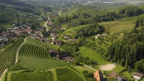 Aerial view around the village Ringelbach in Germany in the black forest on a sunny day in summer. Backwards flight across the valley.