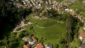 Aerial view of the city Kappelrodeck in Germany in the black forest on a sunny day in summer. Pan to the right around the palace.