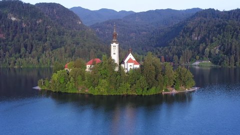 Lake Bled and the Church island of the assumption of Mary, Aerial footage on a beautiful Slovenian summer day.