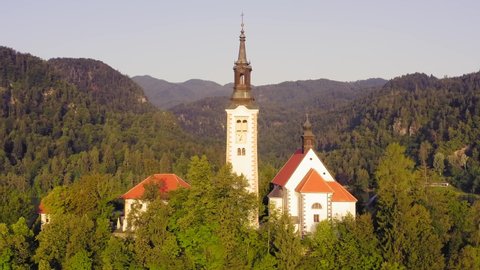 Lake Bled and the Church island of the assumption of Mary, Aerial footage on a beautiful Slovenian summer day.