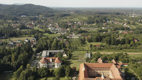 Aerial view around the monastery Franziskanerinnen Erlenbad in Germany on a sunny day in summer. Tilt down on the front of the monastery.