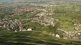 Aerial view around the villages Varnhalt, Steinbach and Neuweier in Germany. Early on a sunny morning in summer. Pan to the left and zoom in beside Steinbach.