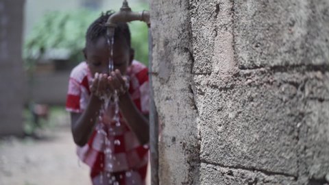 Human Rights Issues, African Black Ethnicity Girl Woman Drinks Fresh Clean Water from Tap