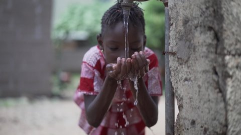 Close Up of African Black Ethnicity Girl Beautiful Drinking Water for Health