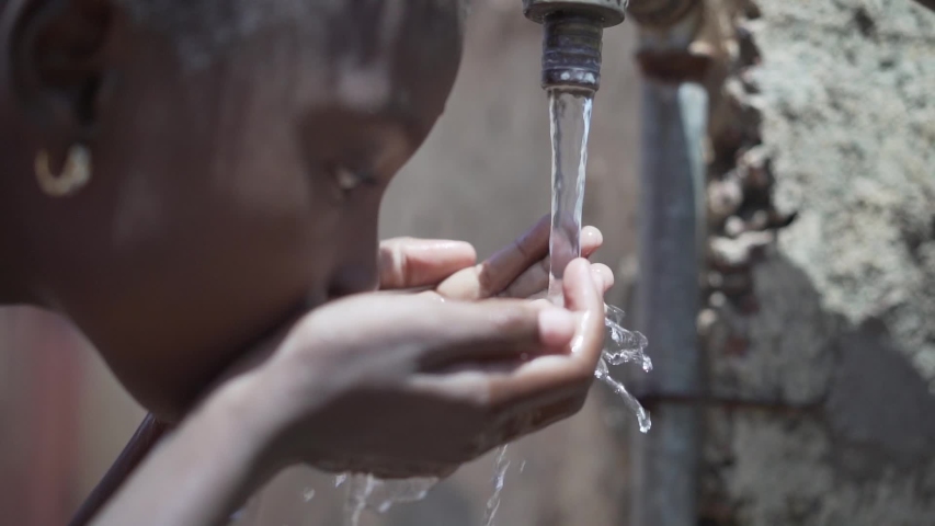 Portrait Close up of African Black Child Girl Drinking Fresh Water Royalty-Free Stock Footage #1037284295