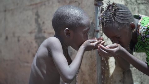 Candid Slow Mo Video of African Ethnicity Children Drink Water Outdoors