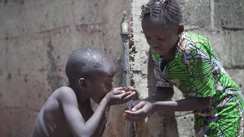 Beautiful Video of African Children Drinking Outdoors Fresh Water from tap