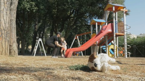 Man abducted a child at playground. A little girl is trying to break out of the hands of a kidnapper. Child left unattended in a playground