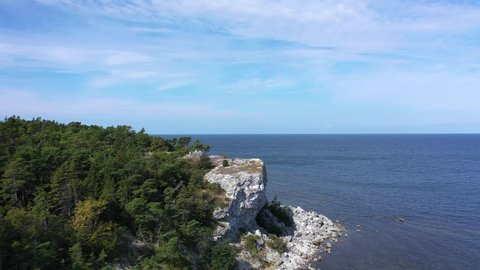 Aerial circling around coastline and cliff edge in Gotland, Sweden