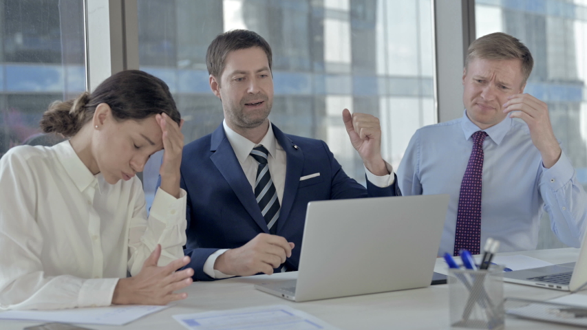 Executive Business people get Shocked while using Laptop on Office Table | Shutterstock HD Video #1037296379