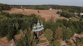 aerial view old wooden church  in traditional village  open air museum of flork architecture  pirogovo v Ukraine Kiev HD video