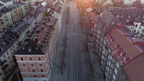 Empty street in Stockholm city, Sweden aerial top down view. Quarantined city, empty abandoned streets during corona virus outbreak. Drone shot flying over buildings and street
