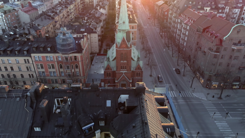 Empty street in Stockholm city, Sweden aerial top down view. Quarantined city, empty abandoned streets during corona virus outbreak. Drone shot flying over buildings and street at sunset Royalty-Free Stock Footage #1037310566