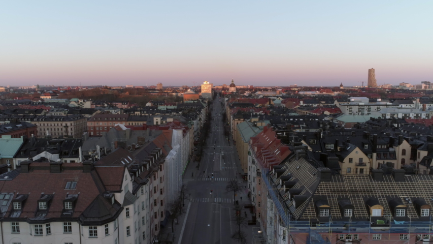 Empty street in Stockholm city, Sweden aerial top down view. Quarantined city, empty abandoned streets during corona virus outbreak. Drone shot flying over buildings and street Royalty-Free Stock Footage #1037310584