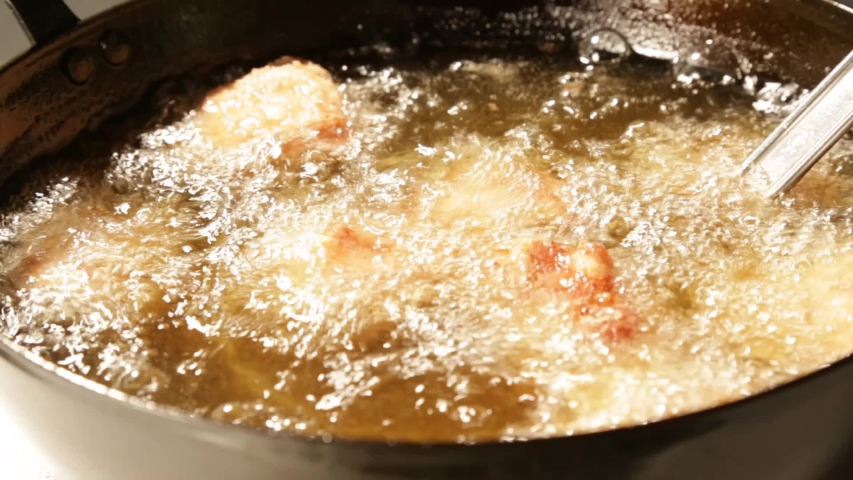 Chicken kara-age (deep-fried chicken) in hot oil and boiling in pan Royalty-Free Stock Footage #1037320904