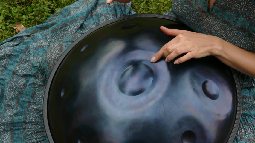 Beautiful female hands on a perfect musical percussion instrument. Sound Meditation