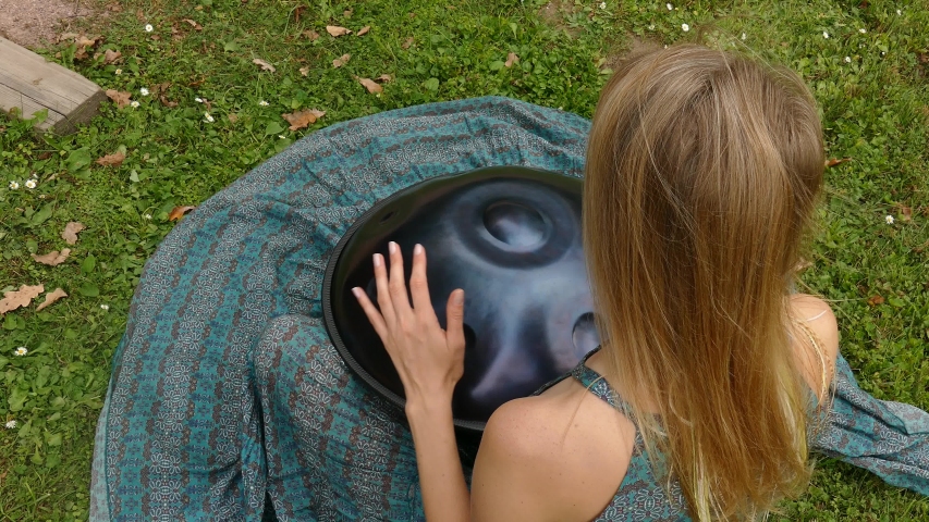 Beautiful female hands on a perfect musical percussion instrument. Sound Meditation