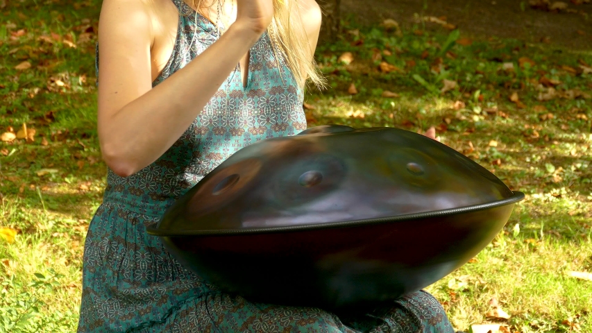 Beautiful female hands on a perfect musical percussion instrument. Sound Meditation