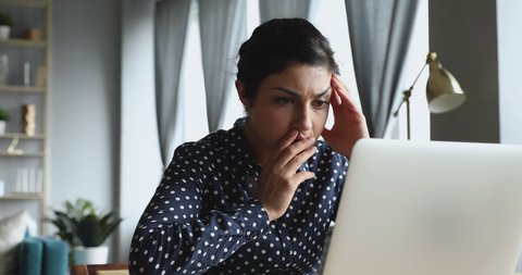 Young indian woman using looking at laptop computer at home office frustrated shocked after reading bad online news got email with failed test exam results feel upset stressed having problem concept