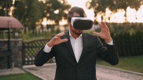 Succesful bearded businessman with virtual reality headset outdoor.