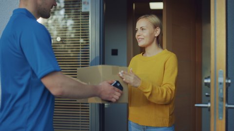 Beautiful Young Woman Opens Doors of Her House and Meets Delivery Man who Gives Her Cardboard Box Postal Package, She Signs Electronic Signature POD Device.