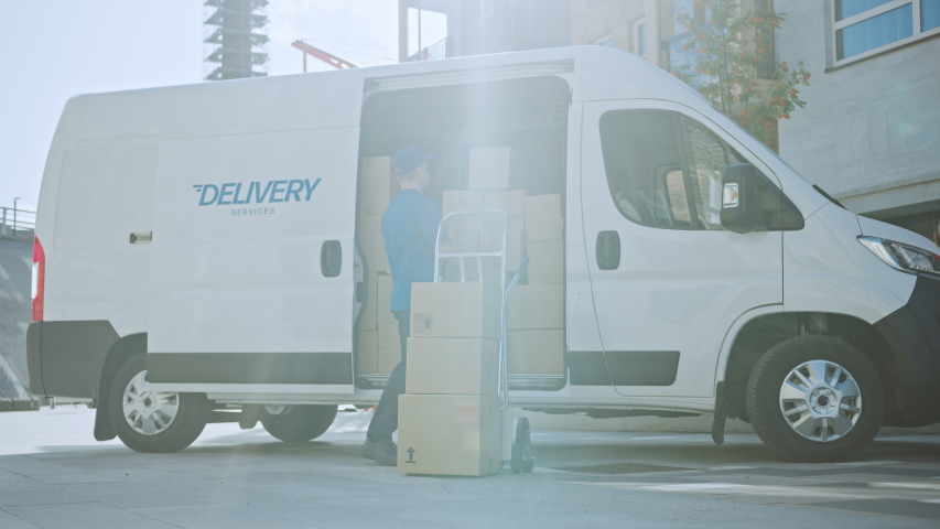 Courier Opens Delivery Van Side Door and Takes out Cardboard Box Package, Closes the Door and Goes on Delivering Postal Parcel. Shot on RED EPIC-W 8K | Shutterstock HD Video #1037351201