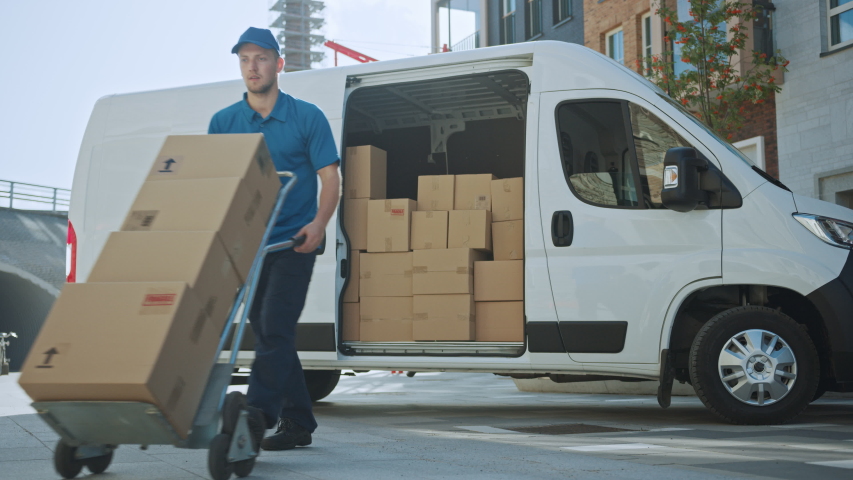 Courier Opens Delivery Van Side Door and Takes out Cardboard Box Package, Closes the Door and Goes on Delivering Postal Parcel. Shot on RED EPIC-W 8K Royalty-Free Stock Footage #1037351201