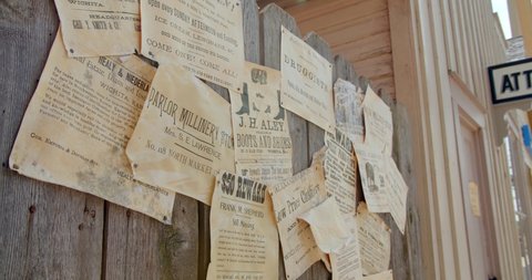 Old Cowtown, Kansas / USA - June 11, 2019: Old Western Notice Board, Wanted Posters, Cowboy Ads Old West