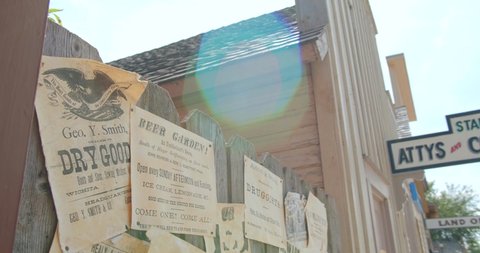 Old Cowtown, Kansas / USA - June 11, 2019: Old Western Notice Board, Wanted Posters, Cowboy Ads Old West Movie Set Ranch Town, Old Cowtown