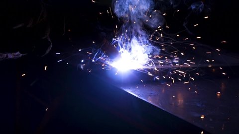 MIG metal inert gas welding side view sparks and smoke in slow motion
