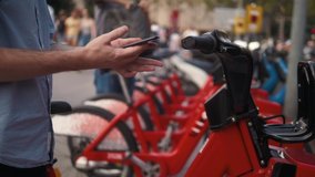 Tourist man take Electric Kick scooter or bike bicycle in sharing parking lot, tourist phone application. New sharing business project started in city, eco transportation - Powered by Shutterstock - Get 15% off with code: PIKWIZARD15