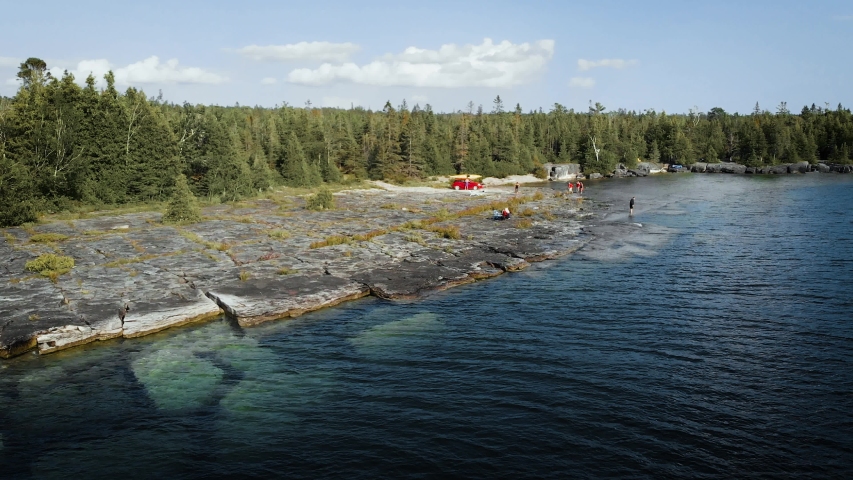 View from drone flying over Meldrum Bay and lake Huron in Manitoulin Island, Ontario, Canada on a hot summer day.