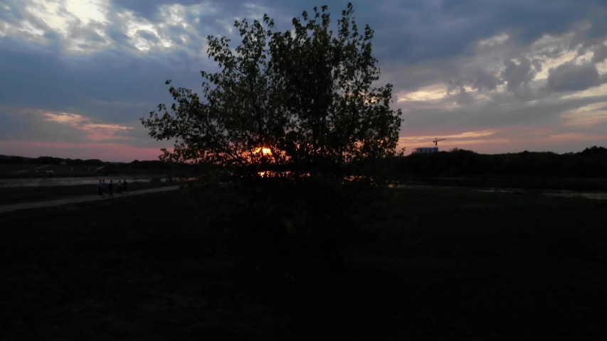 4k rising aerial of a cloudy sunset over a confluence on the River Neman near Kaunas, Lithuania