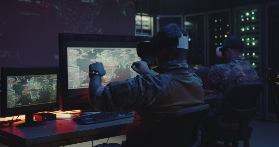 Medium shot of soldiers using VR headsets while sitting at their desks Royalty-Free Stock Footage #1037382599
