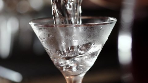 Martini is poured into glass in slow motion