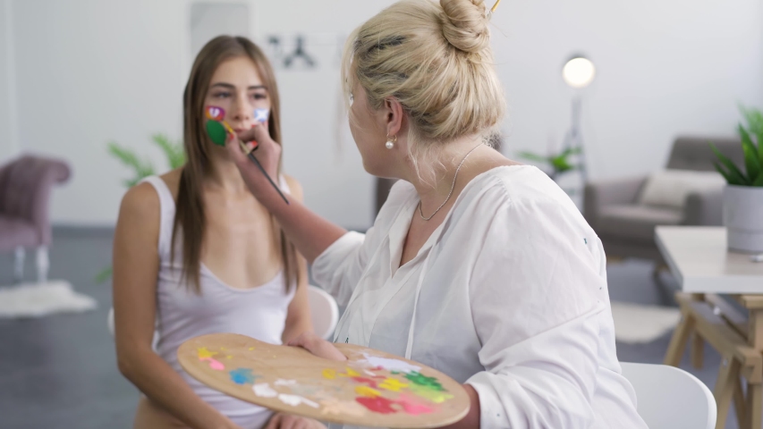 Artist painting on the girl