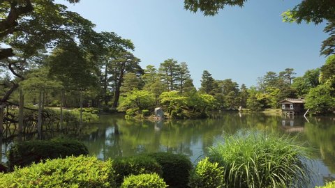 Beautiful pond with a small island in the Japanese Park Kenroku-en in Kanazawa City. Recorded on a sunny day in may.