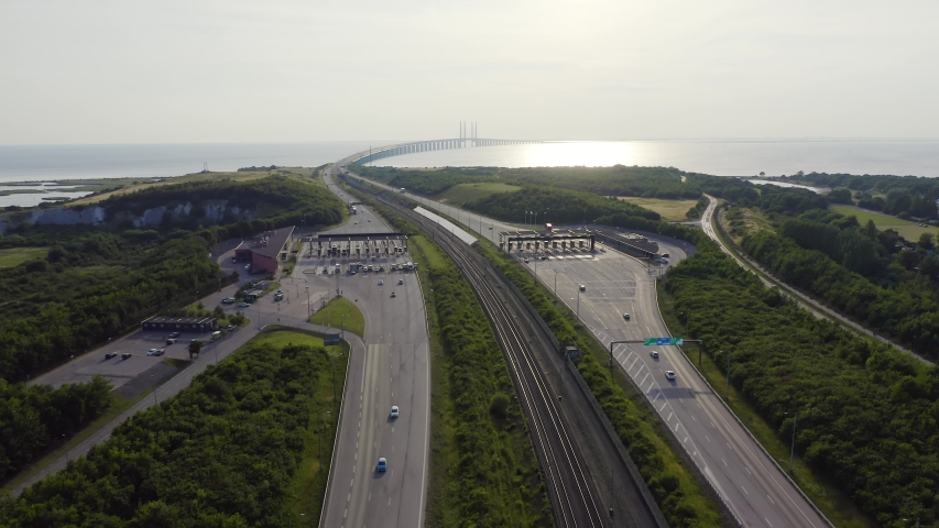 Malmo, Sweden. Oresund Bridge and tunnel crossing the sea to Denmark, with artificial island and toll station at golden hour. Aerial view  