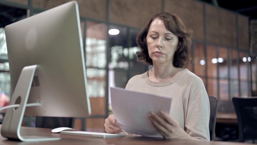 Creative Woman Studying Documents at Work | Shutterstock HD Video #1037397668